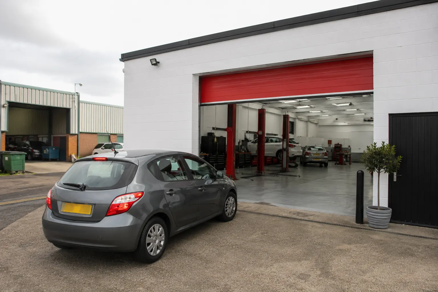 A customer car arriving at a bright independent local garage